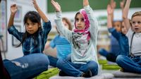 Elementary students stretching in class