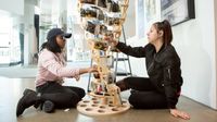 Two high school students work on a photography installation
