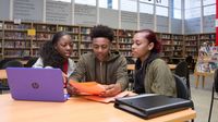 High school students study together in a library