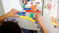Elementary student works on a fractions activity in class