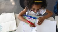 Elementary student draws a rainbow