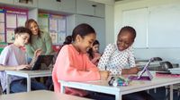 Middle school students in classroom on computer