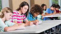 Middle school students write in class
