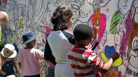 Elementary school children paint mural for a community project.