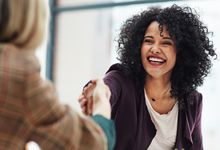 Woman shaking hands during a job interview