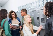 A diverse group of students converse at their lockers.