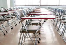 Neat rows of desks fill a classroom.
