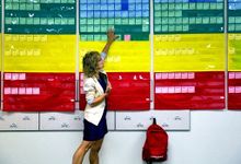 Teacher pointing to a wall of color coded cards