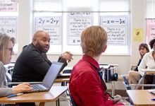 Teachers meeting in a classroom