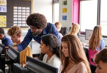 帮助学生使用电脑的高中老师。