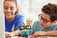 Elementary students work with LEGO robots