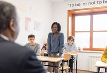 Middle school student standing in classroom