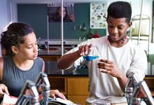 Middle school students do chemistry experiment in school. 