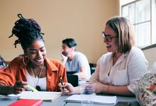 Two teachers meet in classroom