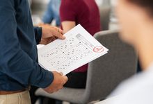 Teacher hands back paper with grade on it