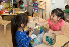 Two kindergarten students participate in an activity center together