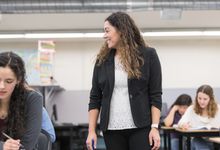 High school teacher walks among her student in class