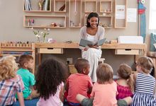 Preschool teacher reads to her students 