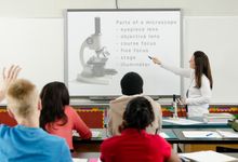 Science teacher using a slideshow in class