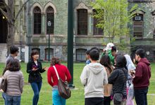 Prospective university students listening to a tour guide during a campus tour
