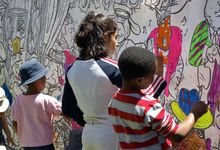 Elementary school children paint mural for a community project. 