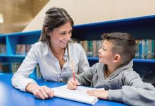 Elementary teacher works with student