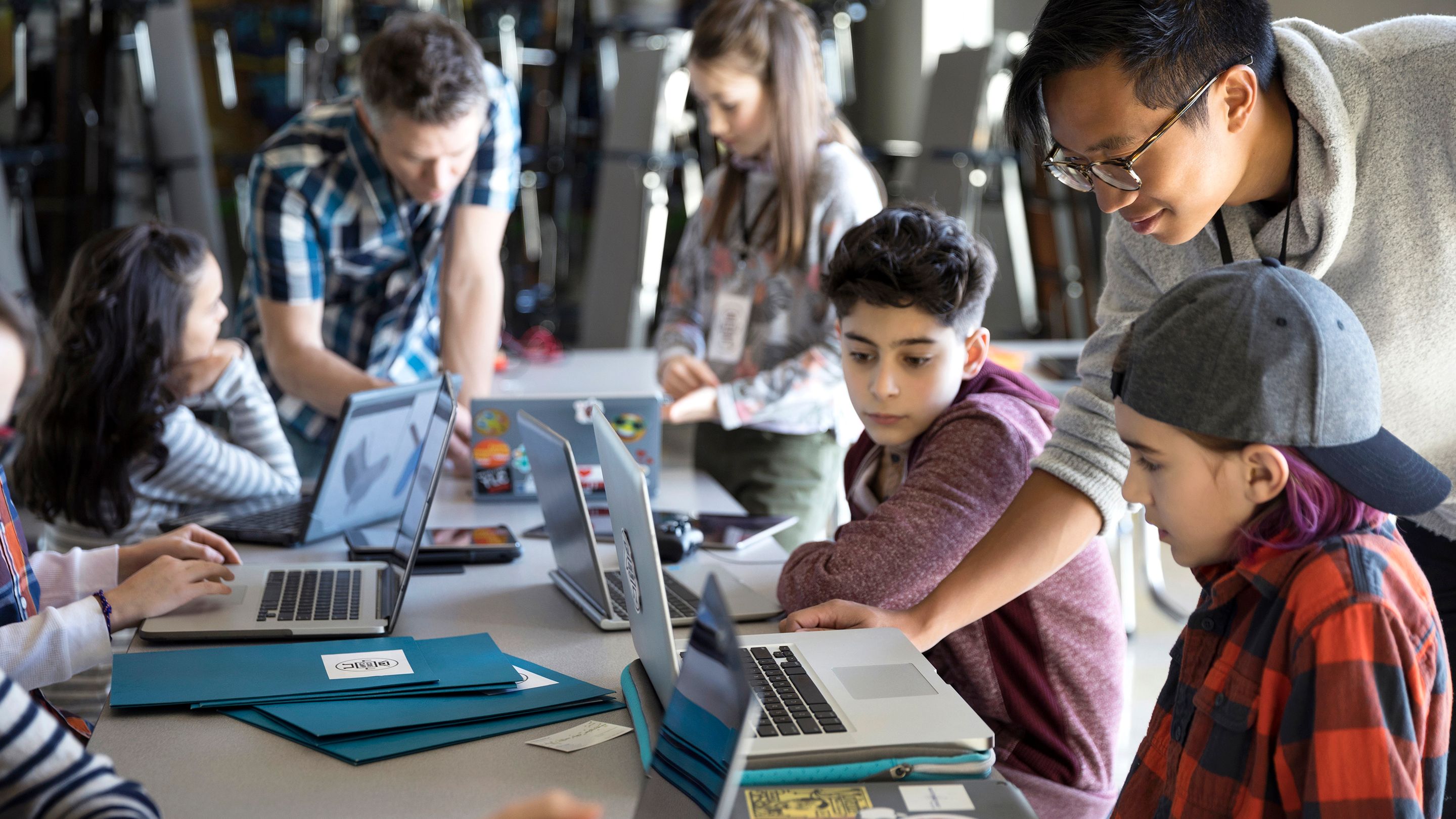 Stock Photo Male Teacher Helping Boys Programming At Laptops In Classroom 232908071 