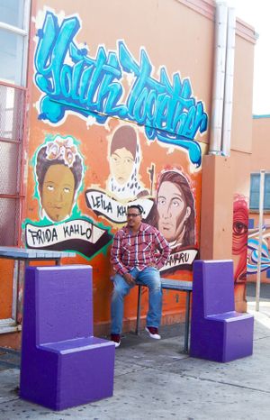 Francisco "Franky" Navarro, restorative justice facilitator at Castlemont High School, sits in the campus courtyard.