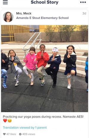 A group of elementary students are doing yoga outside during recess.