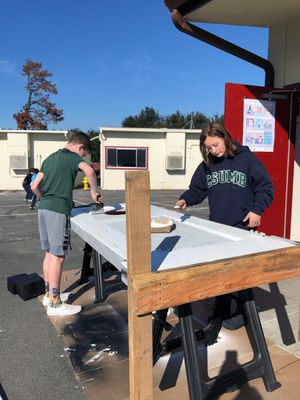 Two students building sets for a school play