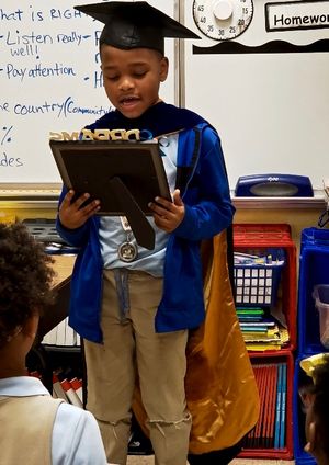 Student reads his college plan to his class.