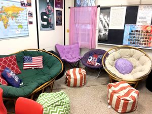 A classroom nook filled with a variety of seating, like lounge chairs and bean bag chairs