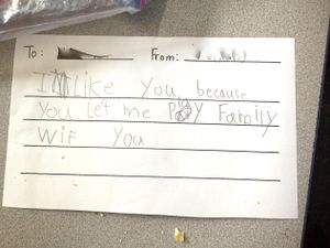 A note from one young student in the writer’s class to another that says, "I like you because you let me play family with you."