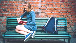 Girl reading on a park bench
