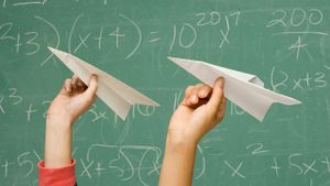 Students throwing paper airplanes