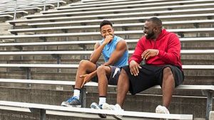 Teen and adult laughing together