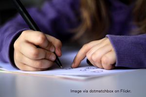 Child writing in notebook