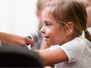 Young student with a microphone