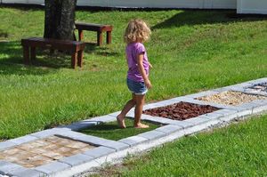 Child walks on sensory path